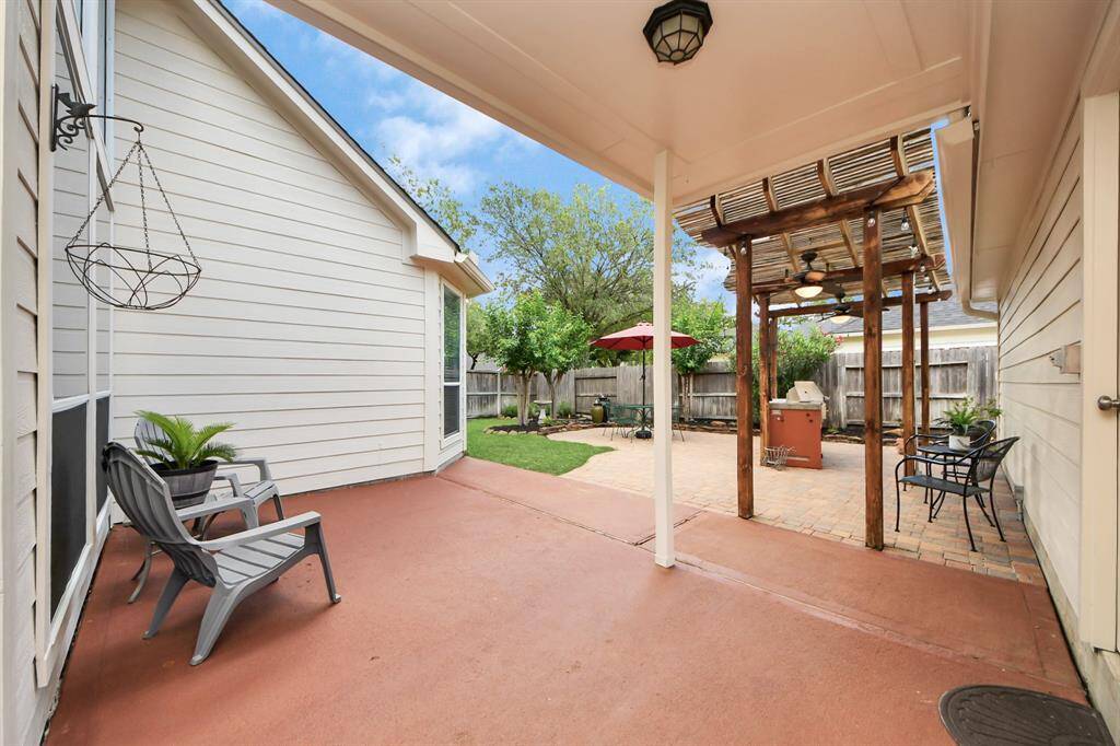Step out the backdoor and embrace the promise of relaxation, where the serene outdoor space awaits, offering the perfect retreat from the day.