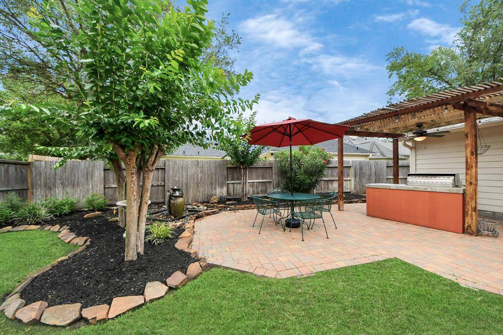 The outdoor kitchen takes the backyard to the next level, offering the perfect setup for cooking and dining al fresco—whether you're grilling for friends or savoring a quiet meal under the stars.
