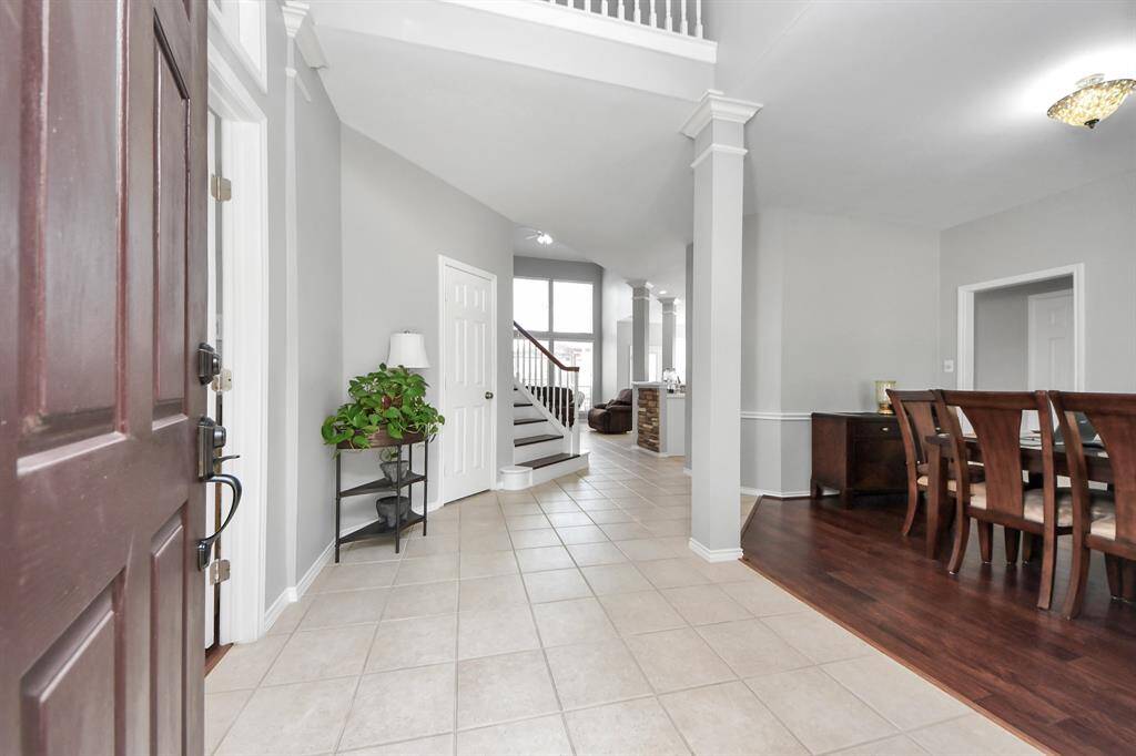 Step inside to an open floor plan that immediately draws you in. You'll fall in love with the crisp neutral tones, sleek wood and tile flooring, and soaring high ceilings that create a sense of spaciousness.