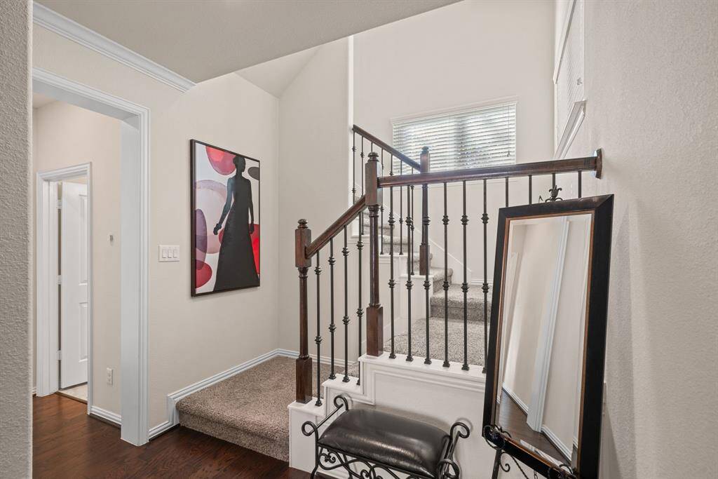 This cozy room features a ceiling fan, neutral carpet, and a door leading outside. A small window allows natural light, and there's a shelf for decor. Ideal for a home office or study.