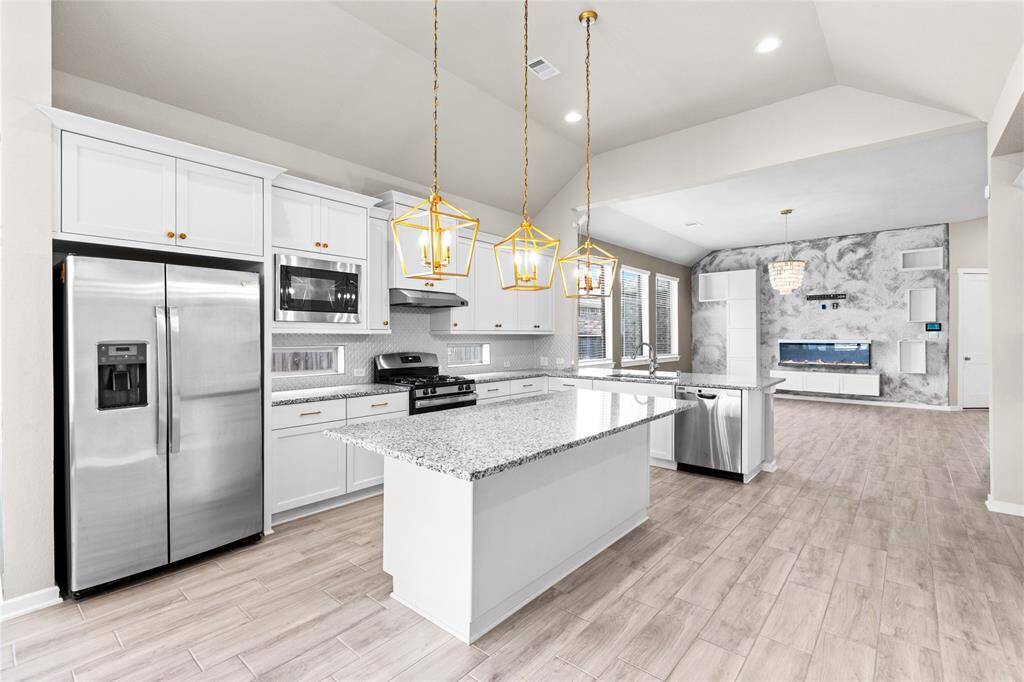 Expansive kitchen with ample storage and sleek stainless steel appliances.