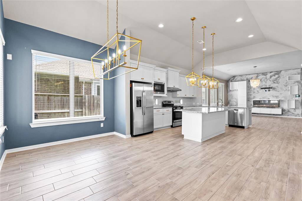 Bright dining area with serene backyard views.