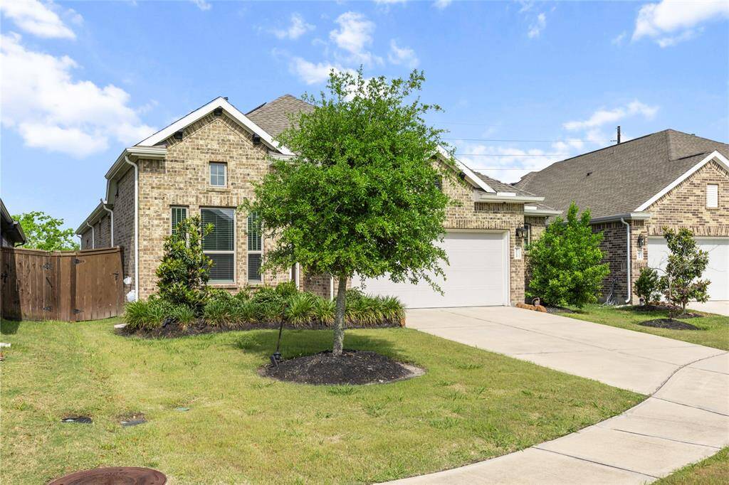 Charming single-level brick home with a spacious two-car garage and stunning landscaping.