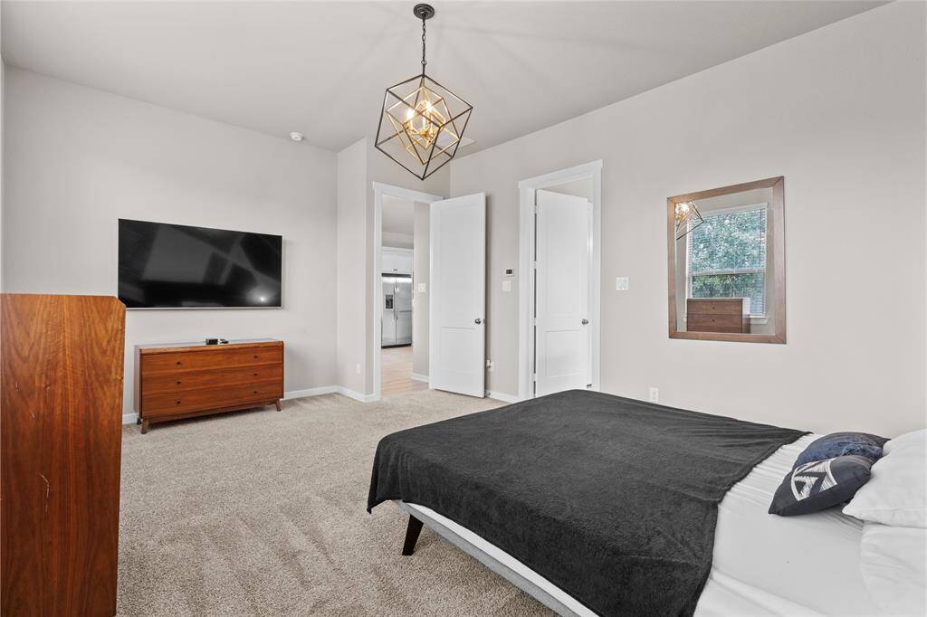 Spacious and inviting primary bedroom perfect for relaxation.