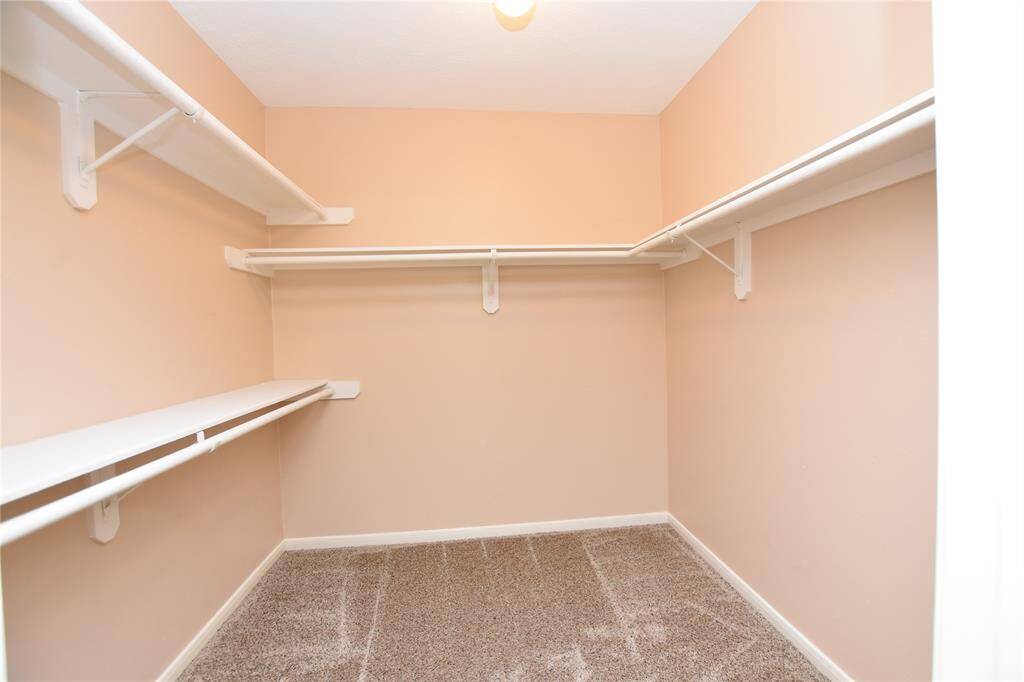 The expansive primary walk-in closets provide ample room for organization and display, ensuring that every item has its place.
