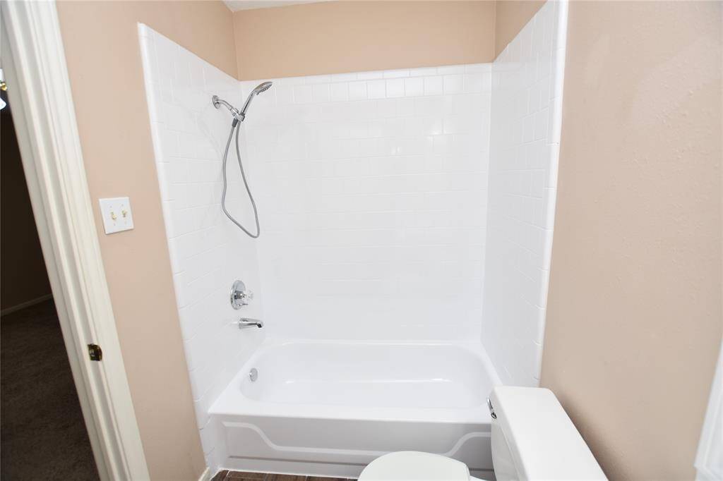 For both practicality and comfort, featuring a clean tub/shower combination that caters to diverse bathing preferences.