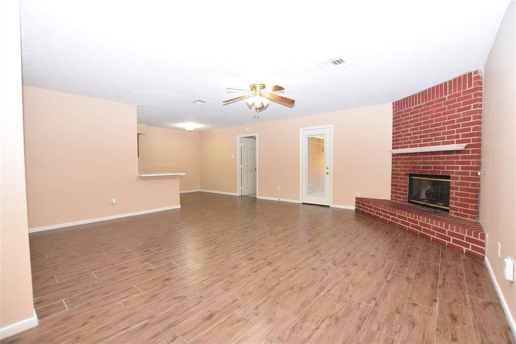 This expansive living room seamlessly integrates with the dining area and kitchen, creating an inviting open-concept space ideal for both entertaining and everyday living.