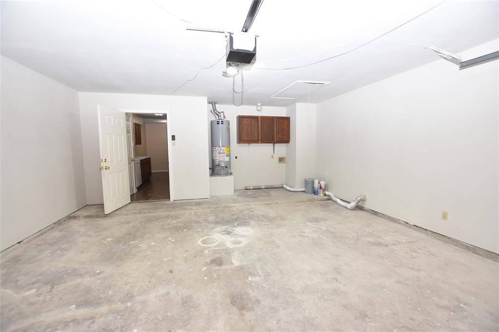This well-maintained garage offers a practical and organized space, featuring dedicated hookups for a washer and dryer