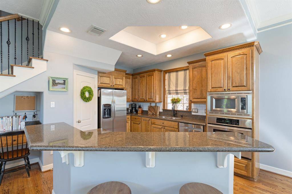 The kitchen island has a breakfast bar that provides additional seating, and overlooks the living room.