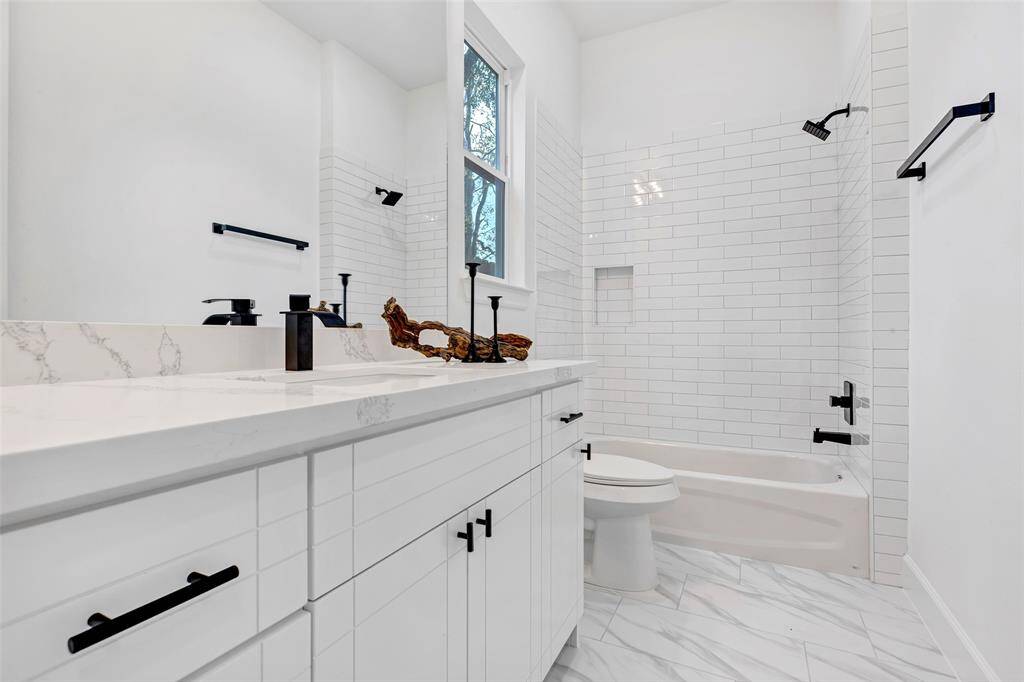 The first floor bathroom features a combo tub and shower.
