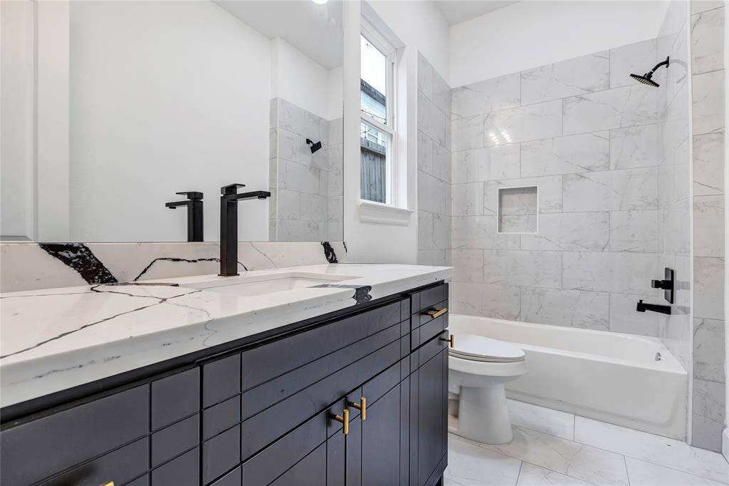 The first floor bathroom features a combo tub and shower.