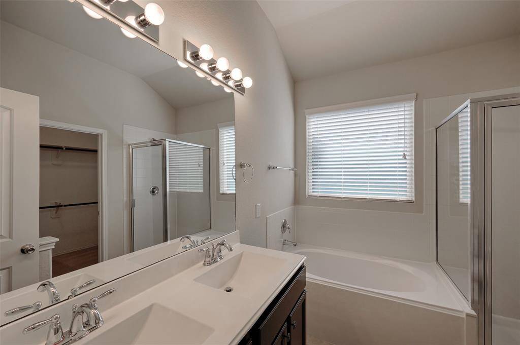Primary bath with double sinks, soaking tub, separate shower and large walk in closet.