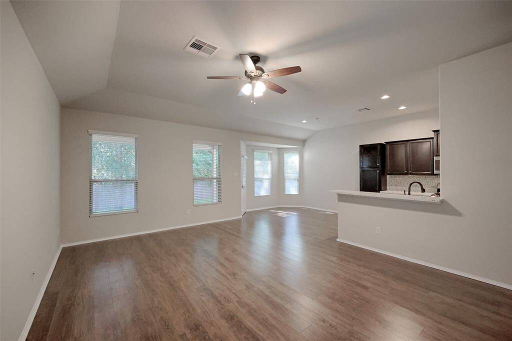 The large living room is bright and open to the kitchen and dining area.