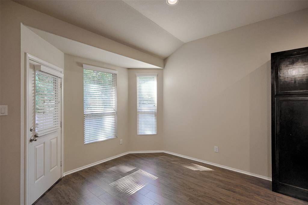 Dining area is bright with a bay window overlooking the shaded back yard.