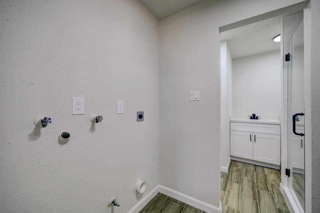 A practical combination space that includes a dedicated laundry zone and full bathroom.