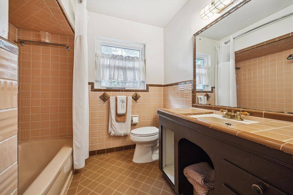 BATHROOM TWO.   Vintage charm in abundance with this gorgeous warm tile.