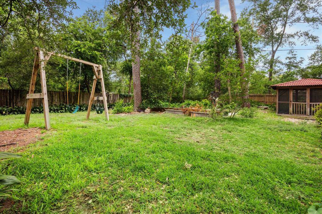 BACKYARD.   The acreage behind 9741 Warwana means that the back neighbors are quite a distance away and you cannot see another home out the back.  Which if you know Houston, this is very rare if you live near the city.  It feels like country living yet HEB is 5 mins away!