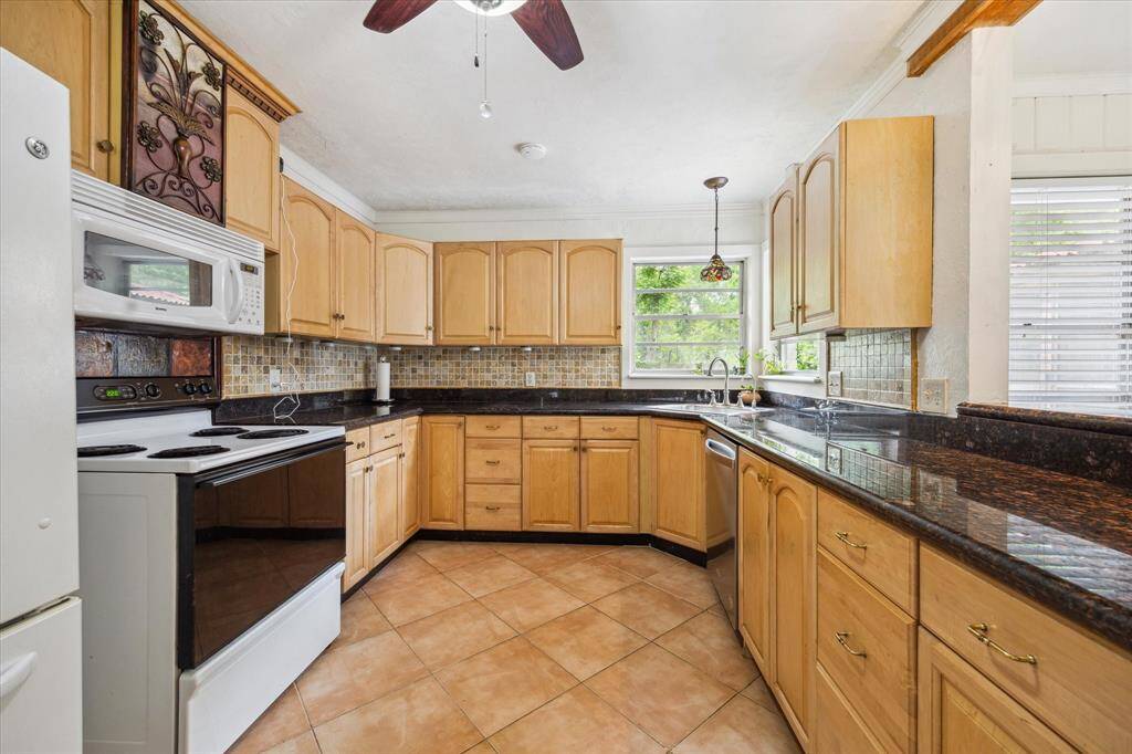 KITCHEN. Tons of cabinetry and a view out over the backyard. Not a home in sight out of this kitchen window. Recent dishwasher.