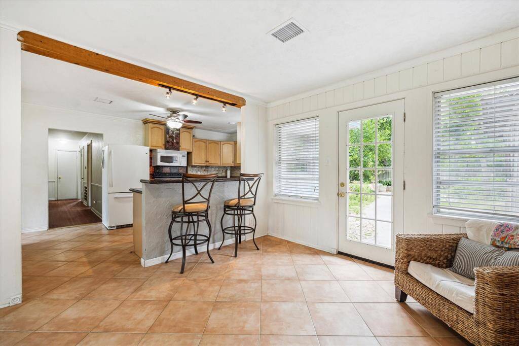 SUNROOM. Such a lovely spot for a cup of coffee and view out over the backyard.  Note the breakfast bar seating for quick meals on the go.