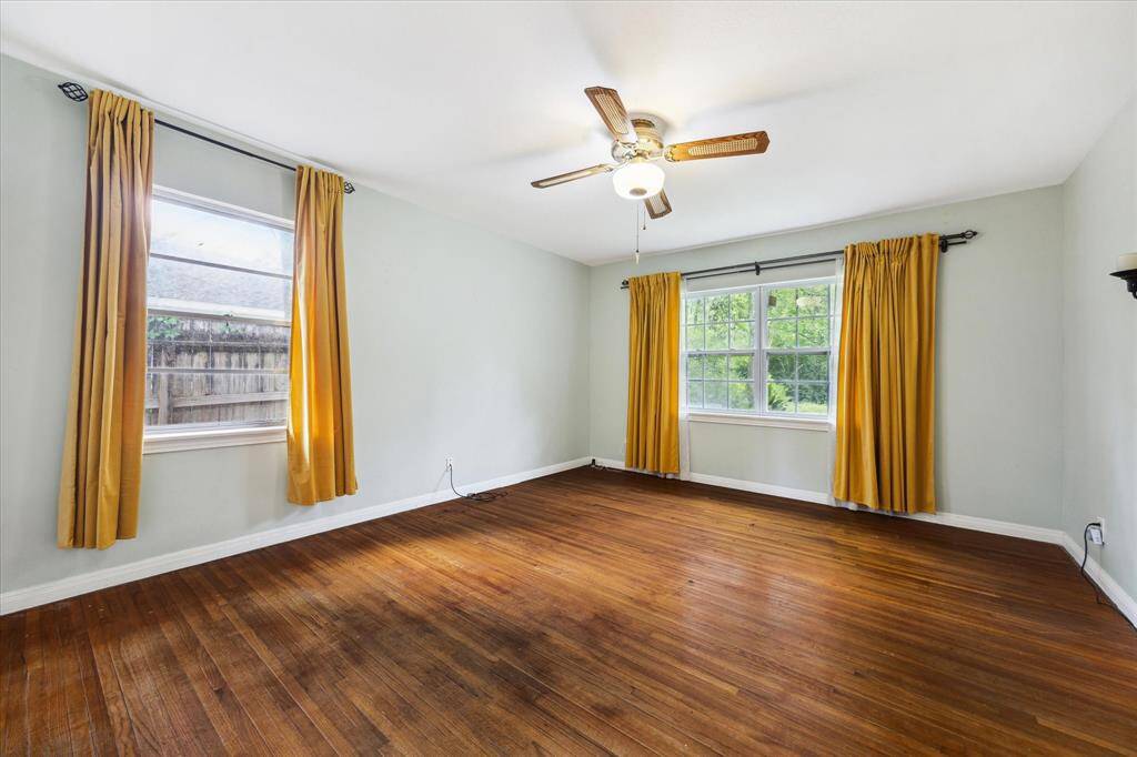 PRIMARY BEDROOM.  Tucked away at the back of the home with backyard views, it's easy to imagine you live in the country and not in Houston!