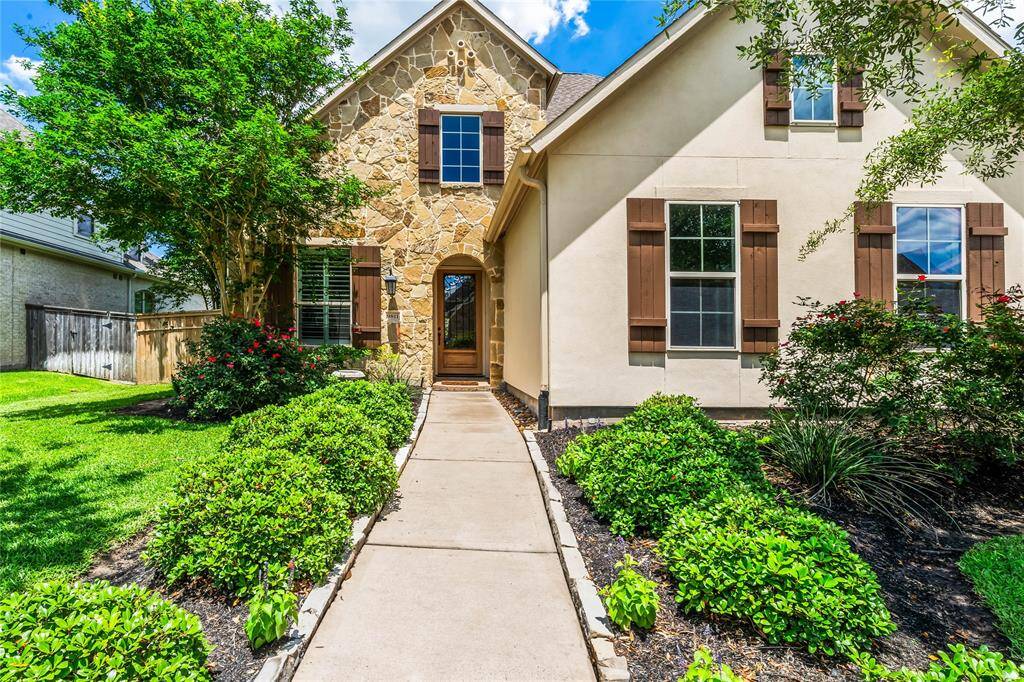 Charming two-story home with a spacious driveway and three-car garage. Features a well-maintained lawn, mature trees, and attractive exterior with a mix of brick and siding. Ideal for families seeking a welcoming and stylish residence.