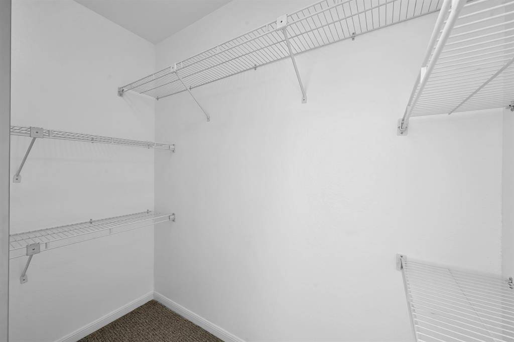 Primary bedroom walk in closet.