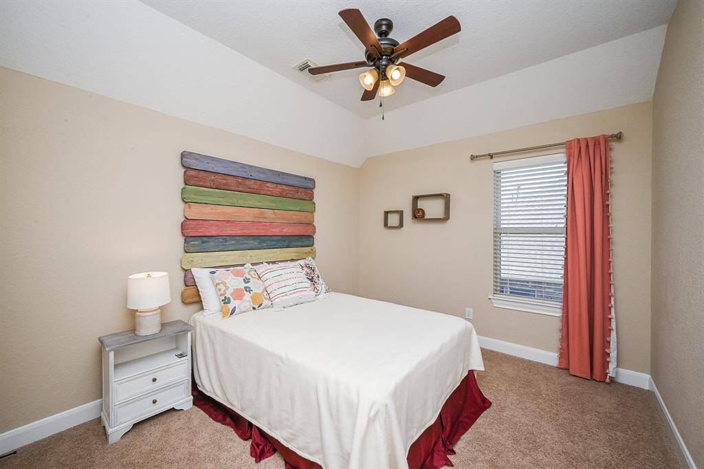 A secondary bedroom is spacious and inviting, for family and guests, alike.