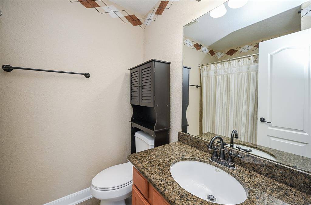 A winning blend of rustic/modern fills this bath with combined shower/bathtub for convenient personal options.