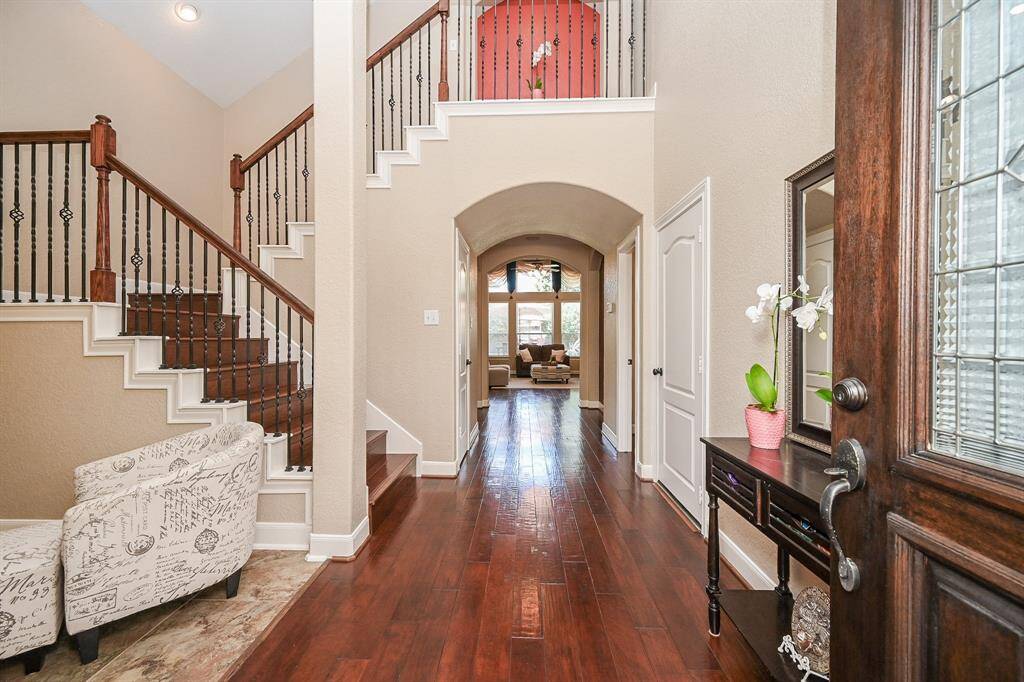 Prominent columns complement walls/crown molding in this view from the front entry, all the way back to the living area.