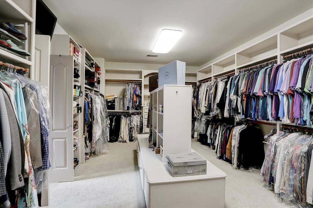 The primary closet. Please note, since these photos were taken the carpet has been removed and replaced with engineered hardwood floors (per seller).