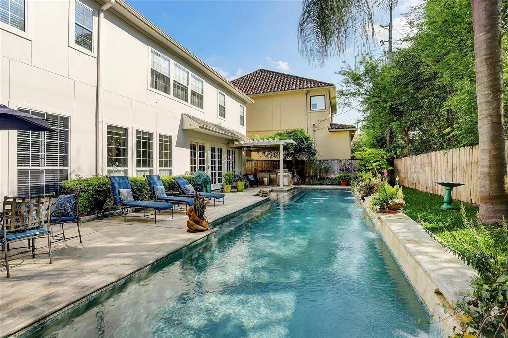 The gorgeous backyard, with a large pool, summer kitchen area, and large deck for entertaining.