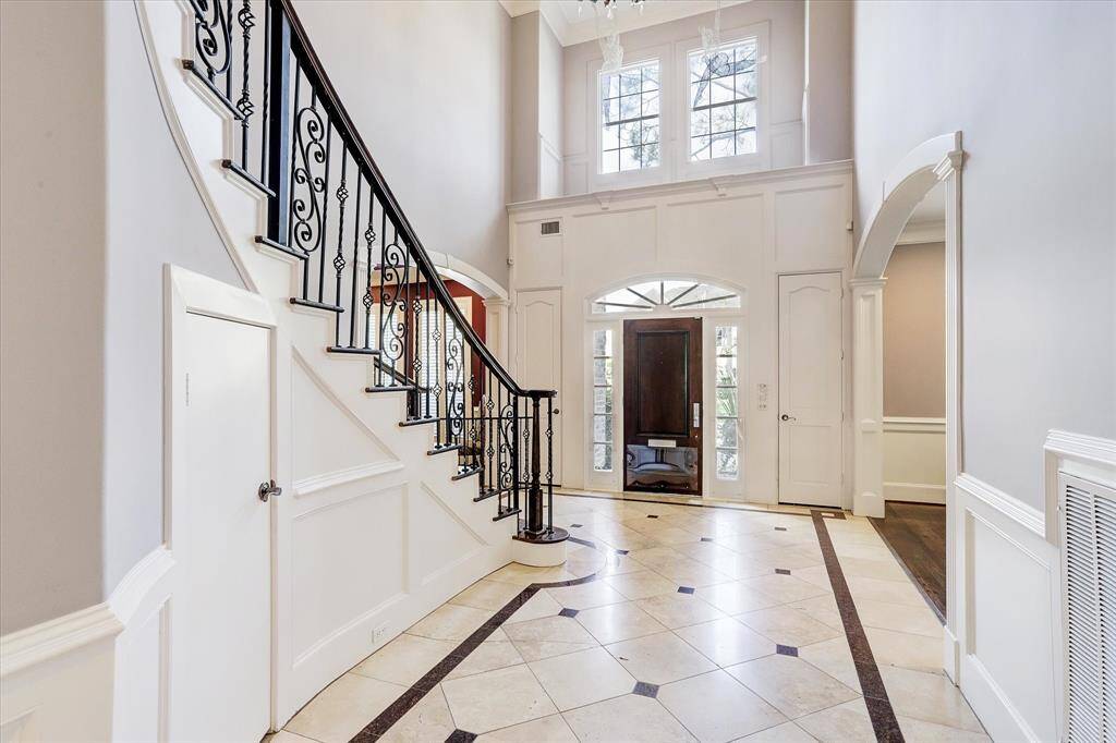 The grand two-story entry foyer leads you to the family room, and is flanked by the dining room and formal living room.