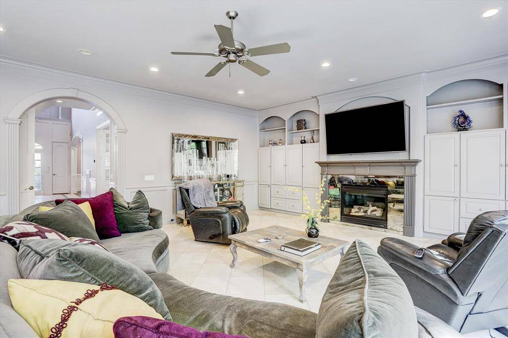 The large family room is the perfect gathering place and is open to the kitchen and breakfast room. The fireplace is mirrored by built-ins.