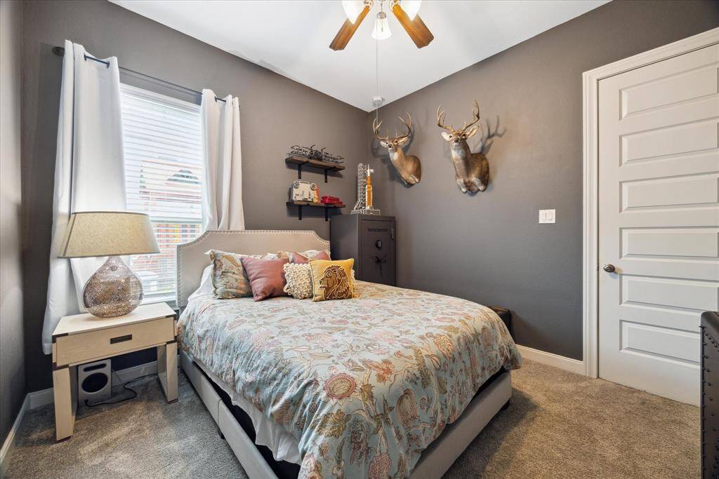 This spacious bedroom is ideal as a guest suite or for those in need of a downstairs bedroom with a spacious closet. Not pictured is the convenient access to a full bathroom, ideal for both this bedroom and guests.