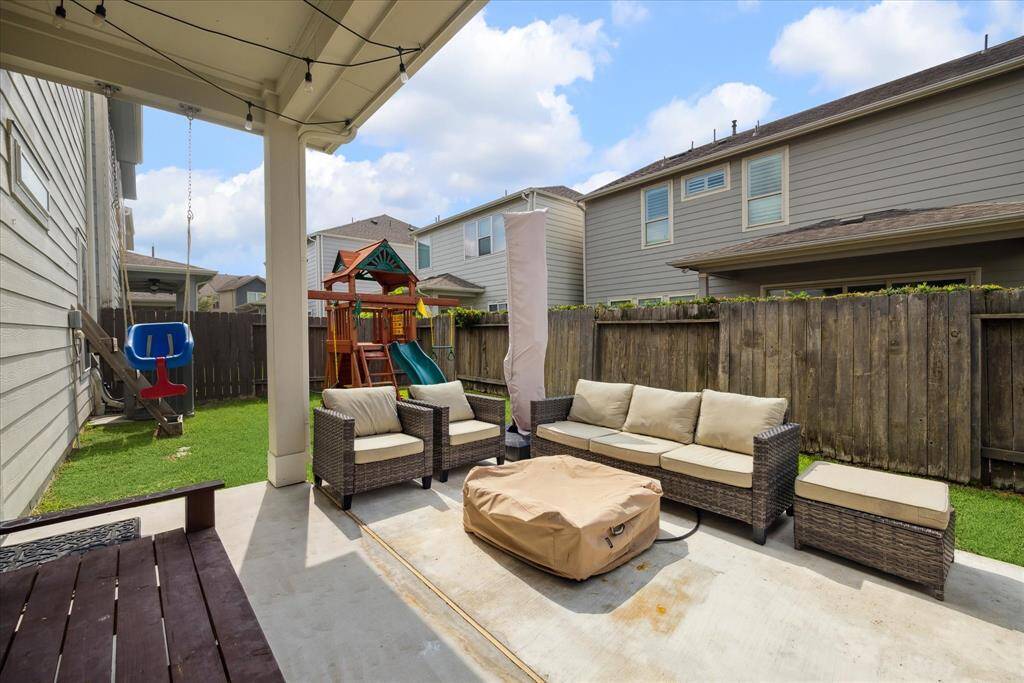 The backyard offers a generous green space for a play set or outdoor activities. Enjoy dining al fresco on the large partially porch, with plenty of room to accommodate an outdoor kitchen, grills, and patio furniture—ideal for entertaining and relaxation. One of the largest backyards in the community!