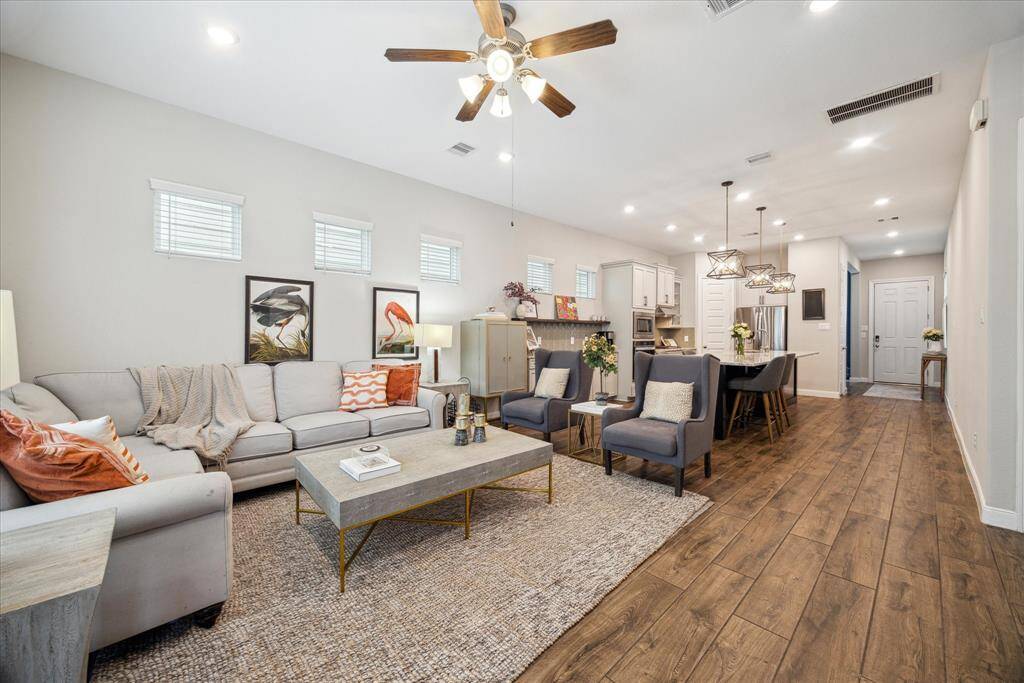 A view from the spacious family room, designed with an open-concept floor plan perfect for entertaining. This inviting space flows seamlessly into the kitchen and dining areas, creating a welcoming atmosphere for gatherings and family time.
