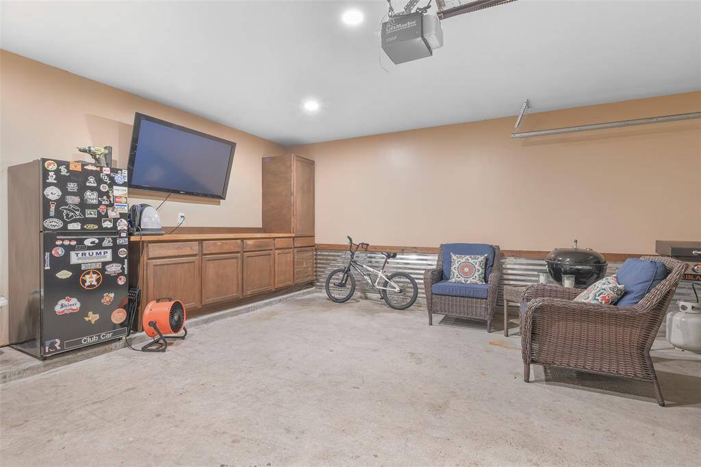 Even the 2-car garage is noteworthy as it makes for a great man cave! It offers recessed LED lighting, aluminum wainscotting, neutral paint, a workbench with butcher block counters, and a hurricane-rated garage door with a garage door opener.