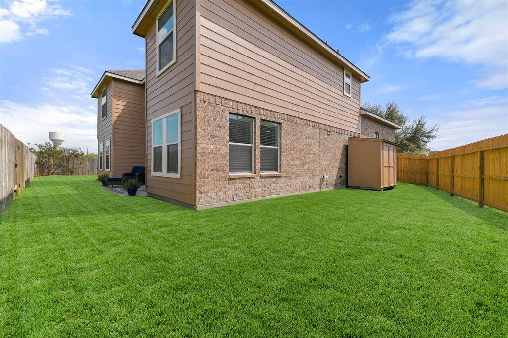 Take a step around to the west side of the yard and you'll find a new privacy fence and a carpet of lush St Augustine grass for kids or pets to run on. On this side, there is also a double-door storage shed for yard equipment, toys, or hobbies.