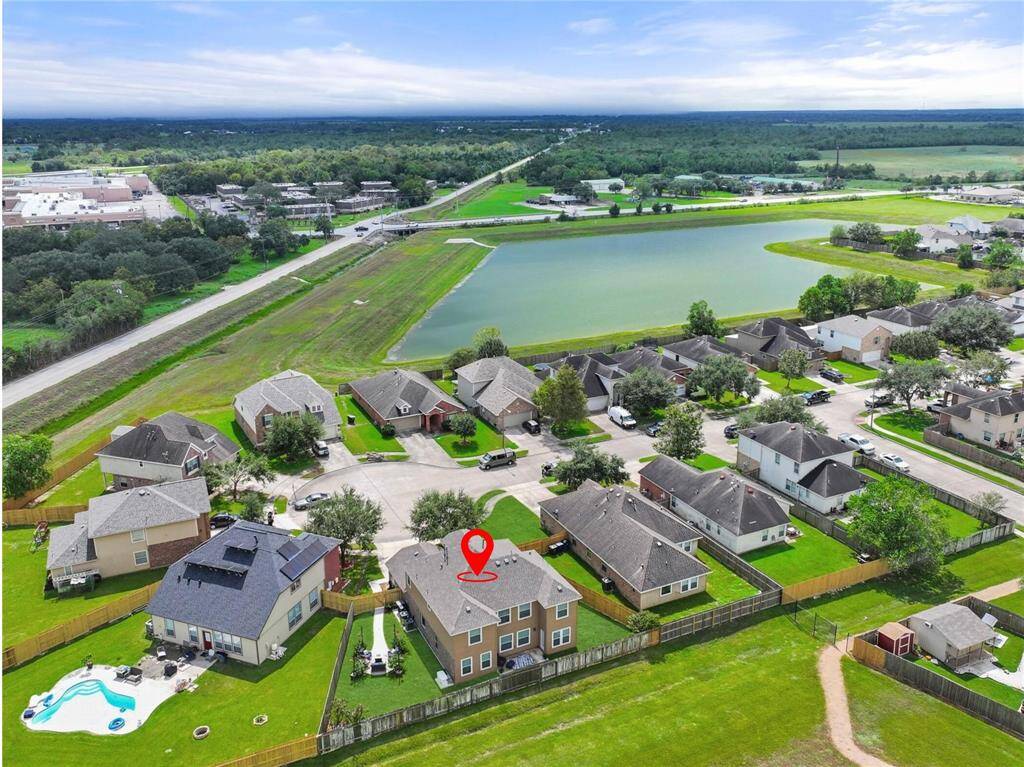 This view from the back side of the home highlights the fabulous location on a cul-de-sac lot and the wide open green spaces surrounding this community in Alvin, which is close to grocery shopping, the YMCA, and Alvin Community College.