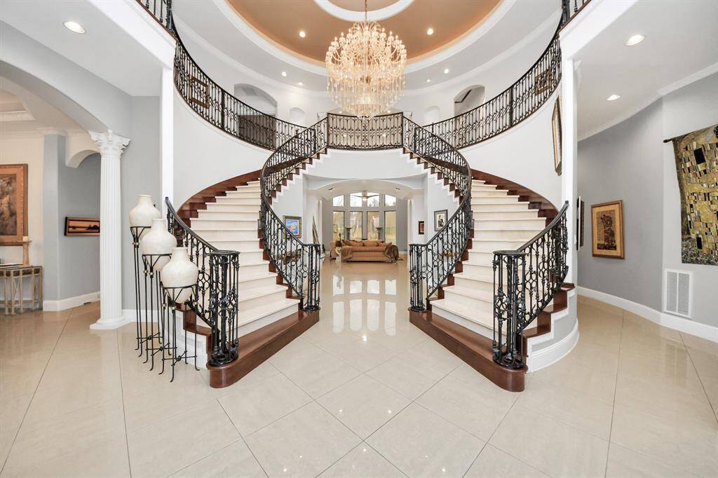 Stunning dual winding staircase with gorgeous chandelier!
