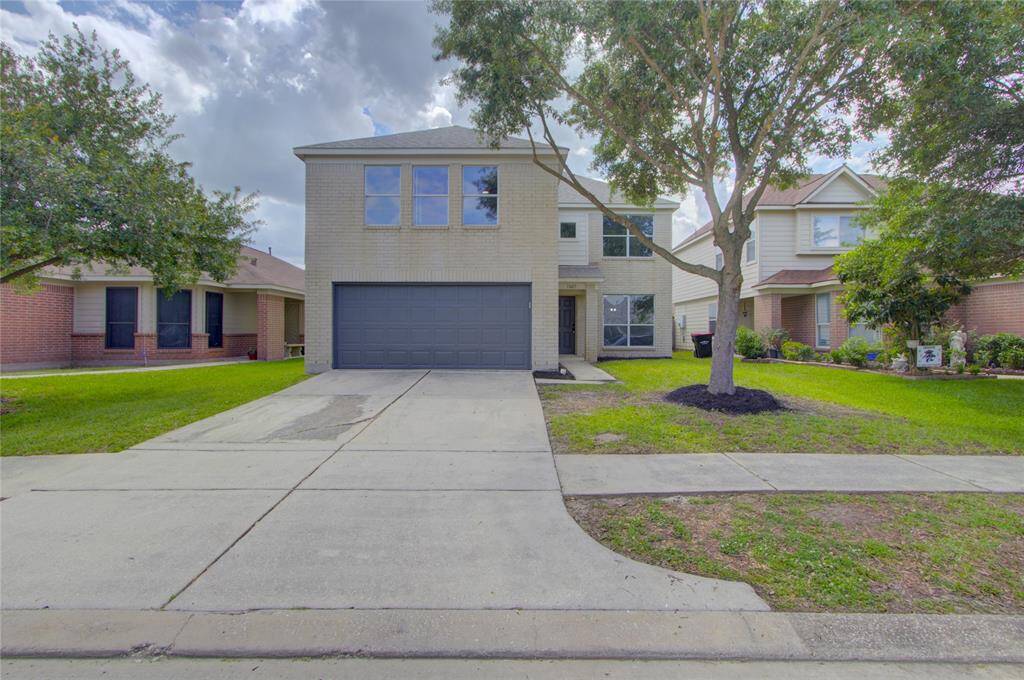 The expansive layout includes a family room with a cozy fireplace, a formal dining area, and a spacious kitchen equipped with a gas range, breakfast bar, and pantry—ideal for both everyday living and entertaining.
