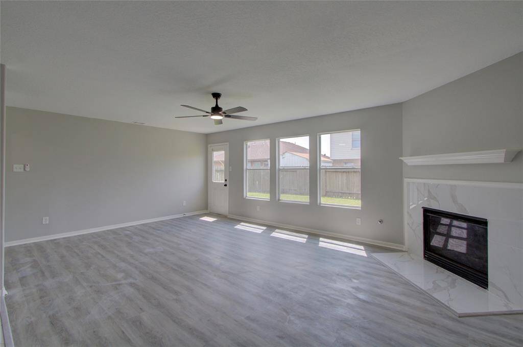 The living area has an open concept with a fireplace that set the perfect ambiance for gathering and relaxing.