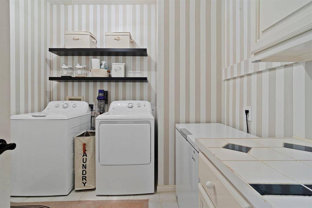The laundry room features tile floors,washer and dryer connections, counter space, andplenty of storage space.