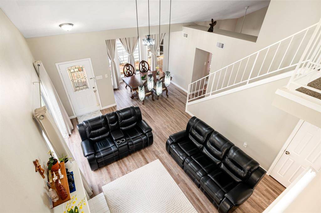 Spacious and bright living area with high ceilings, elegant flooring, and a smooth transition into the formal dining space for effortless entertaining.