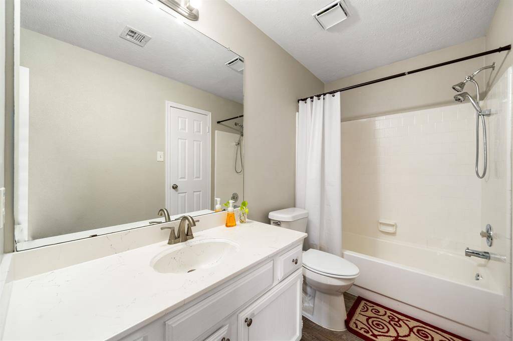 Second bathroom features a spa-like tub and single sink