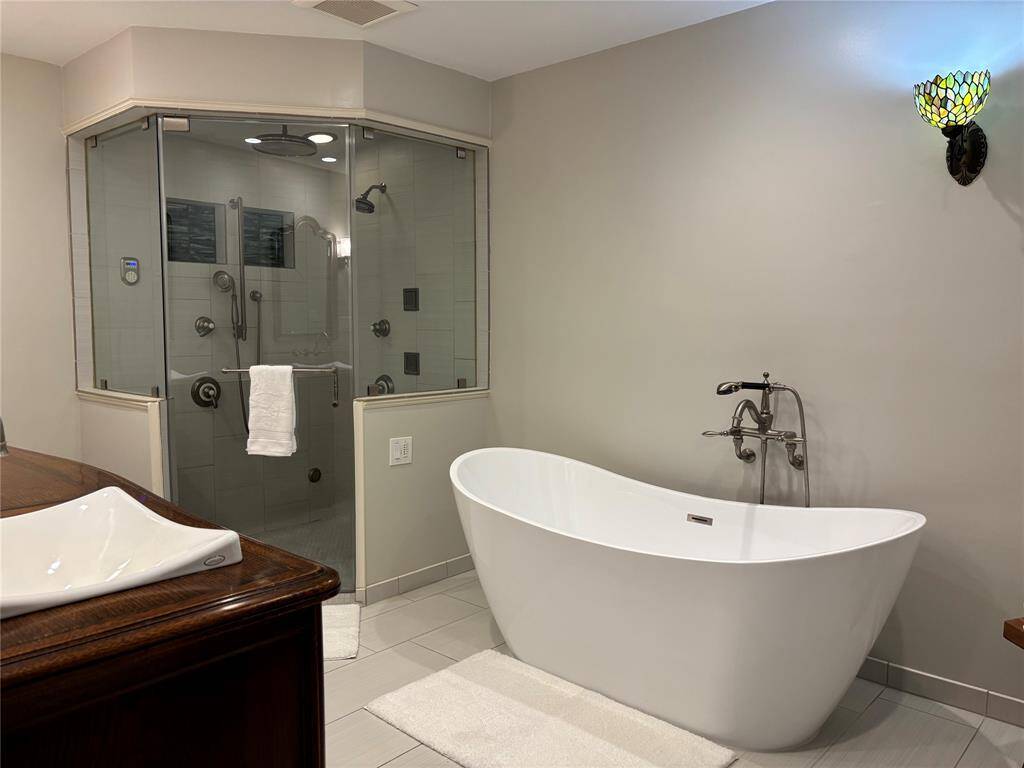 Shower with MANY shower heads/waterfalls gigantic and fancy.