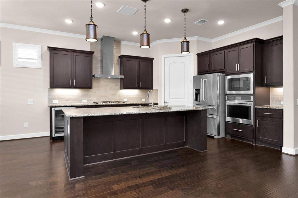 A modern kitchen with high-end appliances, ample counter space, and a convenient center island for meal preparation.