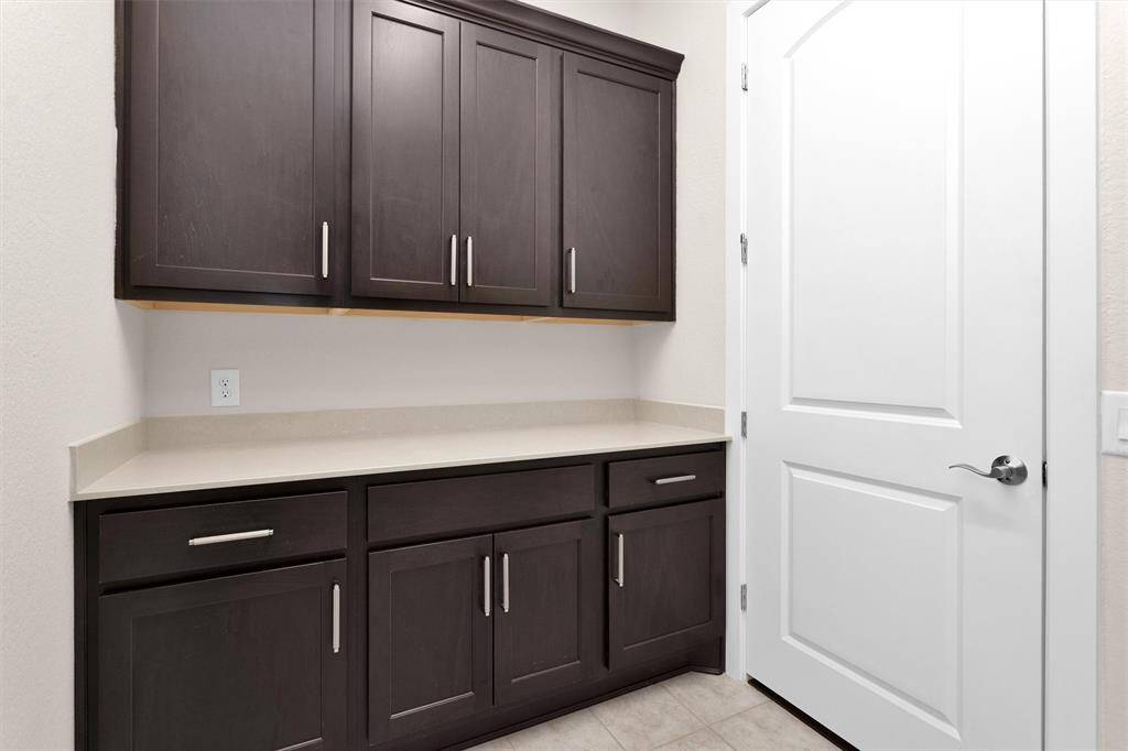 A well-organized laundry room with practical cabinetry and modern appliances.
