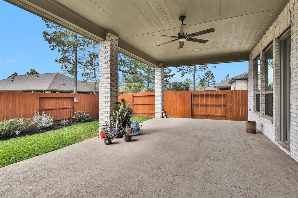 An inviting outdoor patio space with a view of the backyard, ideal for relaxation and outdoor dining.