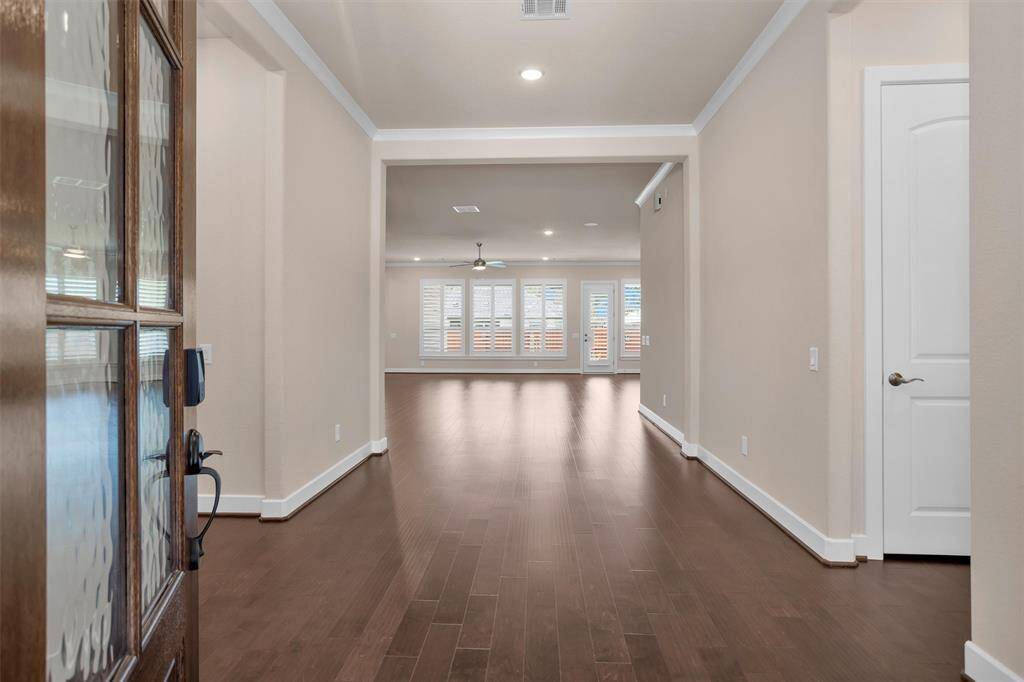 A bright and spacious entryway with stylish flooring and a welcoming atmosphere, setting the tone for the rest of the home.